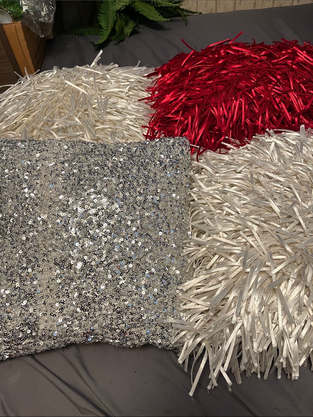 4 unique throw pillows, 2 white, 1 red, 1 silver